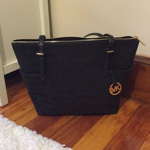 Black Michael Kors tote with gold accents.